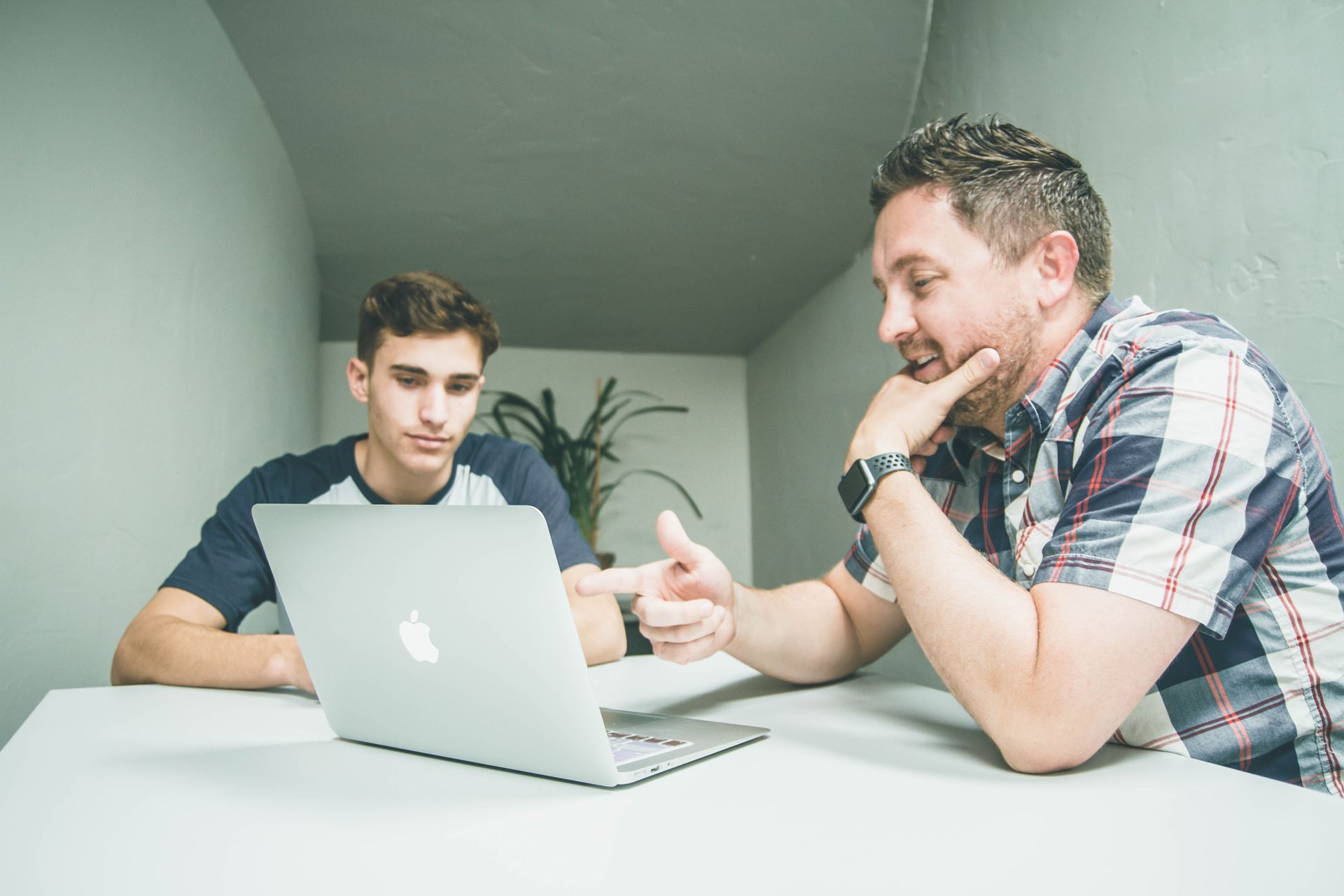 two people at a laptop looking at the screen